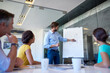 © ArcursPI/peopleimages.com - Presentation, male speaker and graph in office meeting for planning, teamwork and collaboration. Diagram, pitch and corporate people in workplace for deal, project review or b2b with whiteboard