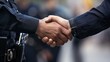 © anatoliycherkas - Close up shot of lifeguards shaking hands, concept of partnership, successful deal and task