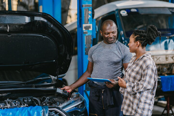 Wall Mural - Mechanic man talking with customer inform explain car problem, service detail in garage.