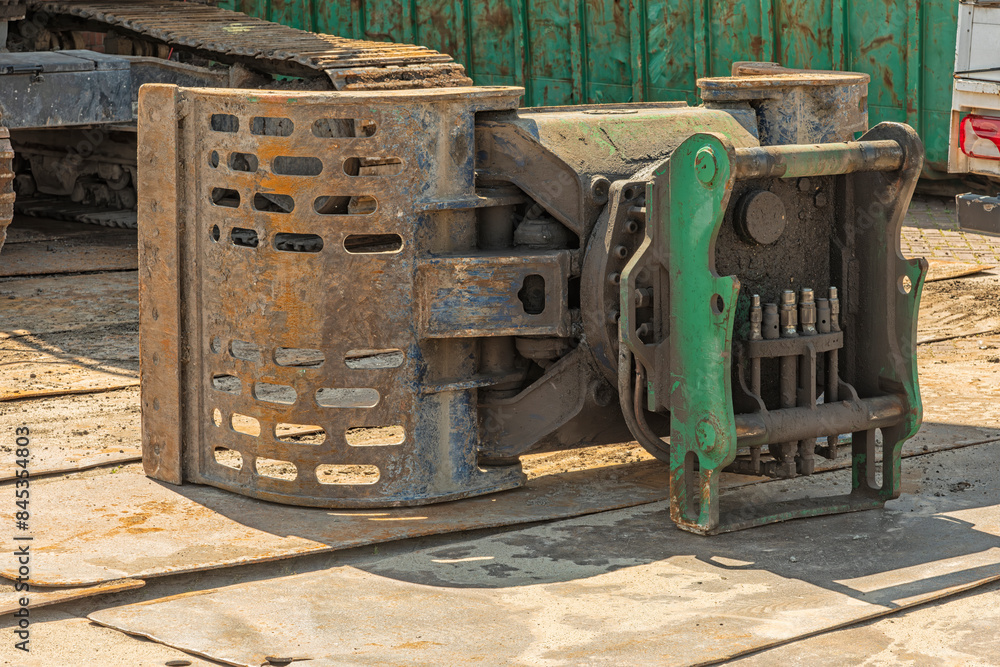 steel hydraulic demolition grab lies outside on steel plates