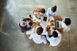 © peopleimages.com - Top view, business people and ideas in meeting, teamwork and cooperation with collaboration. Group, staff and employees with paperwork, technology or portfolio with project, planning or brainstorming