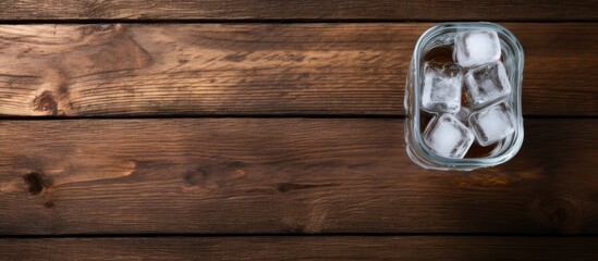 Aufkleber - The ice cubes in glass with water bottle on the old wooden table. Creative banner. Copyspace image