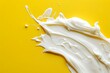 © Anatoll Paveel - Sample smear of white cosmetic cream lotion on a yellow background.