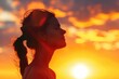 © Isuru - Woman silhouette breathing fresh air at warm sunrise.