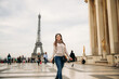 © Aleksandr - Beautiful girl posing to the photographer against the background of the Eiffel Tower. Sunny weather. Beautiful smile and makeup
