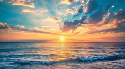 A nature background featuring a sunset with a blue sea and sky adorned with clouds.