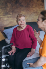 A social worker talks to a lonely old woman.Loneliness of elderly people