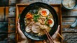 © Plaifah - Person enjoying a traditional Japanese ramen noodle soup with sliced pork, bamboo shoots, and soft-boiled egg