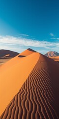 Wall Mural - A panoramic desert scene with tranquil sand dunes, arid terrain, and a vivid blue sky
