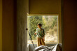 © rh2010 - Young woman paints walls while making repairment of a new house. Standing with paint roller and looks out. Creative process of home renovation and repair concept
