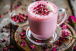 © Emanuel - Trendy and romantic pink latte made with hibiscus tea, garnished with dried rose petals, perfect for a fashionable food or beverage advertisement
