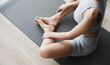© kite_rin - Young beautiful woman practicing yoga in yoga studio. Young beautiful girl doing exercises on gray yoga mat. Harmony, balance, meditation, sport, healthy lifestyle concept