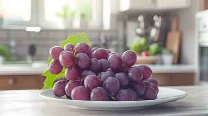 Wall Mural - Fresh purple grapes on a clean white plate, with a cozy, homey kitchen backdrop.
