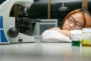 Wall Mural - girl scientist sleeping in laboratory. emotion of education and science