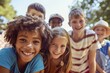 © Iigo - Portrait of smiling multiethnic group of children looking at camera in park