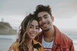 © Markus Schröder - Portrait of a blissful latino couple in their 20s wearing a trendy bomber jacket on sandy beach background