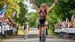 © Jelena - victorious female cyclist crossing finish line on road bike triathlon race action shot