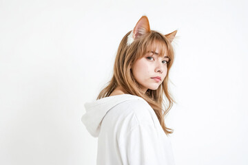 Wall Mural - Woman in white hoodie with cat ears looking over shoulder