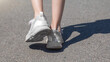© Mariia - close up of child legs walking away from camera in the road
