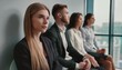 © Marko - Young people are sitting in a row in business center while waiting for the interview
