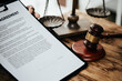 © aksonsat - Close up of hands Lawyers explain and discuss matters of law and contract agreement to clients discuss for prepare for the trial. gavel hammer and scales of justice.