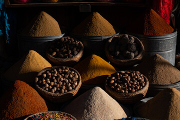 Market stall with collection of different spices in bowls