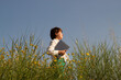 © Alina - Digital nomad woman travelin, field of daisies horizontal photo, girl with laptop in nature