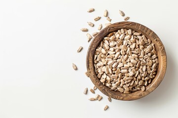 Wall Mural - White background with sunflower seed filled bowl