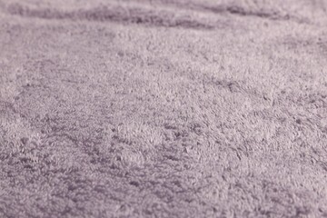 Dry soft pale purple towel as background, closeup