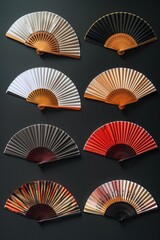 A collection of differently colored fans placed on a black surface