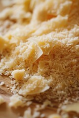 Wall Mural - A pile of shredded cheese sits on top of a wooden cutting board, ready for use in various recipes