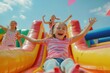 © Fotograf - A young girl enjoying the fun on a water park inflatable slide
