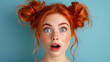 © Andres Mejia - Portrait of shocked beautiful redhead woman posing on blue background showing surprised face expression