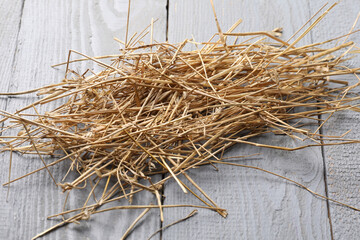 Poster - Pile of dried straw on grey wooden table