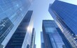 © Mark - Sunlit skyscrapers with reflective glass facades against clear sky. Modern office building and towering skyscraper, building vibes