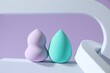 © New Africa - Stylish presentation of makeup sponges on violet background