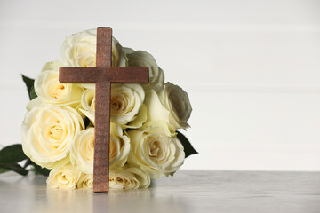 Wall Mural - Bible, cross and roses on light wooden table against white background, space for text. Religion of Christianity