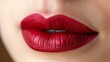 © steve - Bold Red Lips: Model's lips adorned with bold red lipstick. The close-up highlights the texture and shine of the lipstick. Fashion. Cosmetics. Beauty.