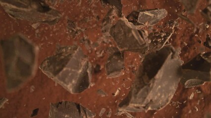 Canvas Print - Super Slow Motion of Falling Group of chocolate pieces. Falling Down into Cocoa Powder. Filmed on High Speed Cinema Camera, 1000fps.