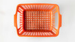 © Rabil - Top view of a green plastic shopping basket on a white background