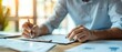 © Naret - Focused businessman in formal attire signing important documents at the office desk during daylight. Business, work, and signature process.