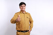 © ArvStd - Happy Indonesian government employees standing with thumbs up gesture. Isolated on white background
