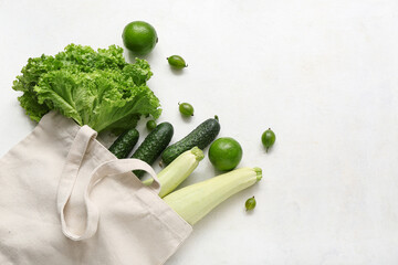 Poster - Eco bag with different fresh vegetables on light background