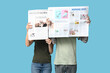 © Pixel-Shot - Couple with newspapers on blue background
