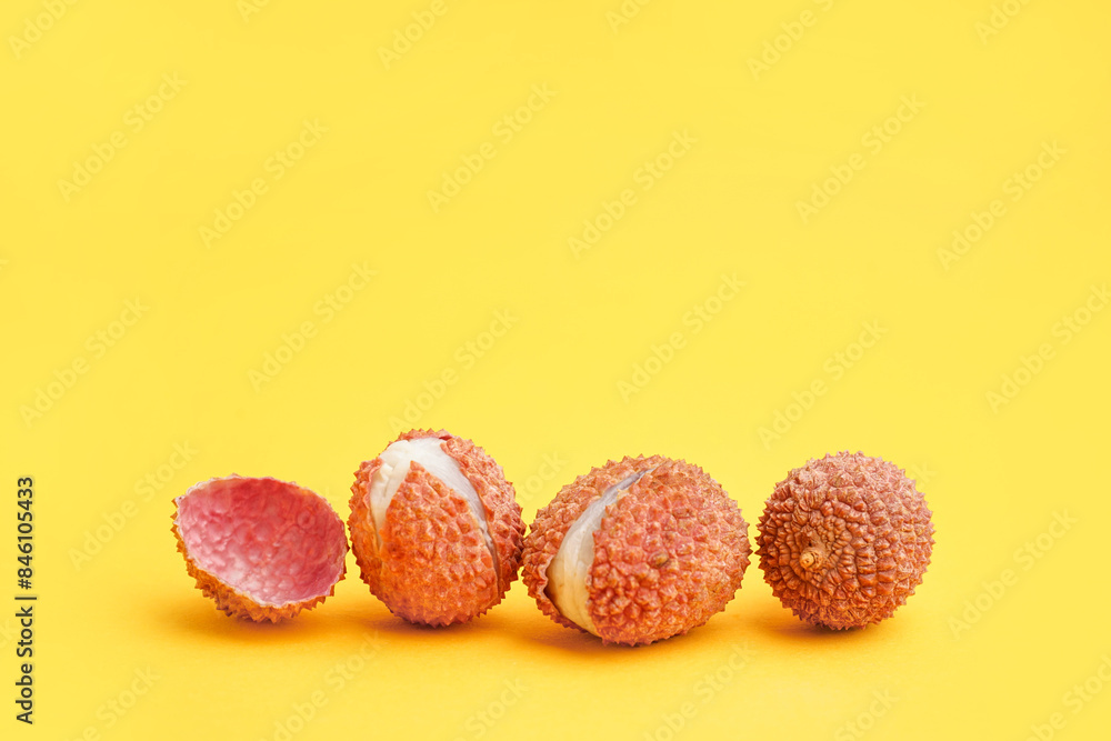 Tasty litchi fruit on orange background