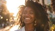 © The Little Hut - Happy cheerful young ethnic black African attractive pretty woman with curly long hair standing outdoor on sunny city street laughing Close up portrait candid authentic shot : Generative AI
