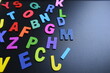 © sutichak - colorful letter alphabet on black background, object for education
