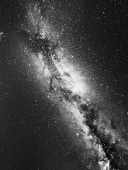 Wall Mural - A black and white photo of a galaxy with a long, thin line of stars