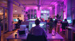 © visoot - Digital agency office, with laptops, and people, purple light. Generative AI.