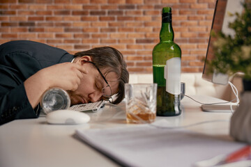 Businessman drunkard sleeping at desk in home office workplace